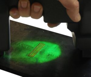 Magnetic particle inspection with fluorescent test agent